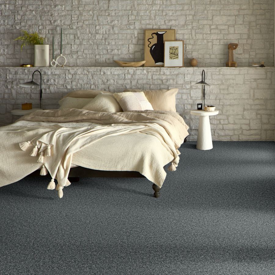 soft grey carpets in a bedroom with stone accent wall